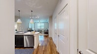Located at 3900 W Northwest Hwy in Dallas, TX, this well-designed two-bedroom, three-bathroom residence offers a thoughtful open-concept layout across a single floor. Rich hardwood flooring flows from the kitchen through to the living room, creating a seamless and cohesive living space.

The kitchen is a standout feature, showcasing dark espresso cabinetry, a classic subway tile backsplash, stainless steel appliances, and a granite-topped center island with seating for multiple guests — ideal for entertaining. Stylish pendant lighting illuminates the space overhead. The adjacent living room is bright and welcoming, with multiple windows inviting natural light and a ceiling fan overhead.

Both bedrooms are comfortably sized, each featuring ceiling fans, natural light from large windows with blinds, and plush carpeting. The primary bedroom includes access to a spacious walk-in closet with built-in shelving and hanging rods. Two of the three bathrooms serve as en-suites; one features a dual-sink vanity with a soaking tub and tiled surround, while the other offers a glass-enclosed walk-in shower, single vanity, and open built-in shelving. The unit also includes a hallway and two closets for additional storage.