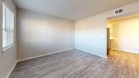 Located at 5477 E 71st St in Tulsa, Oklahoma, this compact and well-organized one-bedroom, one-bathroom unit makes thoughtful use of its single-floor layout. The living room greets you at the entrance with durable wood-look vinyl plank flooring, neutral-toned walls, a textured ceiling, and windows fitted with blinds that allow for ample natural light and outdoor views. The galley-style kitchen is a functional highlight, featuring gray shaker-style cabinetry, light quartz countertops, a white subway tile backsplash, a stainless steel sink, and stainless steel appliances including a refrigerator and gas range. The bedroom offers a generous footprint, covered in plush carpeting and equipped with a ceiling fan with light fixture. It includes a dedicated closet as well as an additional closet housing a stacked washer and dryer unit, providing convenient in-unit laundry. A window in the bedroom brings in natural light. The bathroom is clean and practical, featuring a combination tub and shower with a rainfall-style showerhead, brushed nickel grab bars, and wood-look vinyl flooring. Textured ceilings are found throughout the unit, giving each room a consistent finish. This unit offers a straightforward and efficient living environment suited for single occupancy.