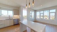 Located in the vibrant Normal Heights neighborhood of San Diego, this single-floor residence at 4499 Ohio St offers a thoughtfully designed, contemporary living experience. The open-concept layout is anchored by a sleek kitchen outfitted with light wood cabinetry, white subway tile backsplash, quartz countertops, and a full suite of stainless steel Whirlpool appliances, including a gas range, over-the-range microwave, dishwasher, and a side-by-side refrigerator. A central island with a waterfall quartz surface provides additional prep space and casual dining, illuminated by a trio of pendant lights with amber Edison bulbs.

The living and dining area is bathed in natural light through expansive windows that frame panoramic views of the surrounding San Diego skyline and swaying palm trees. Light hardwood flooring runs throughout the residence, lending warmth and continuity to every room.

The bedrooms are bright and airy, each featuring large windows with neighborhood views, clean white walls, and ample space. The bathroom is finished with modern floating wood vanity cabinetry, a quartz countertop, a large mirror, and a glass-enclosed walk-in shower with clean white tile surrounds. The overall aesthetic is clean, minimal, and move-in ready.