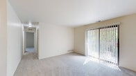 This 2-bedroom, 1-bathroom residence in Clinton Township, Michigan, offers a well-organized single-floor layout that includes a living room, dining room, and kitchen. The living room is a welcoming, carpeted space highlighted by a full-length sliding glass door fitted with vertical blinds, allowing generous natural light and outdoor views of surrounding greenery. The galley-style kitchen is efficiently designed, featuring dark espresso cabinetry, granite-look countertops, tile flooring, and white appliances including a dishwasher, electric range, and refrigerator — providing ample functionality in a compact footprint. The primary bedroom is a comfortably sized carpeted retreat featuring a wide double-door closet, offering practical storage. The second bedroom is equally bright, with a window that fills the room with natural light and plush carpet underfoot. Neutral, light-toned walls throughout the unit create a clean and versatile backdrop. The overall layout is straightforward and functional, with a cohesive design aesthetic that prioritizes practicality. This unit is well-suited for those seeking a manageable, low-maintenance living space in Clinton Township.