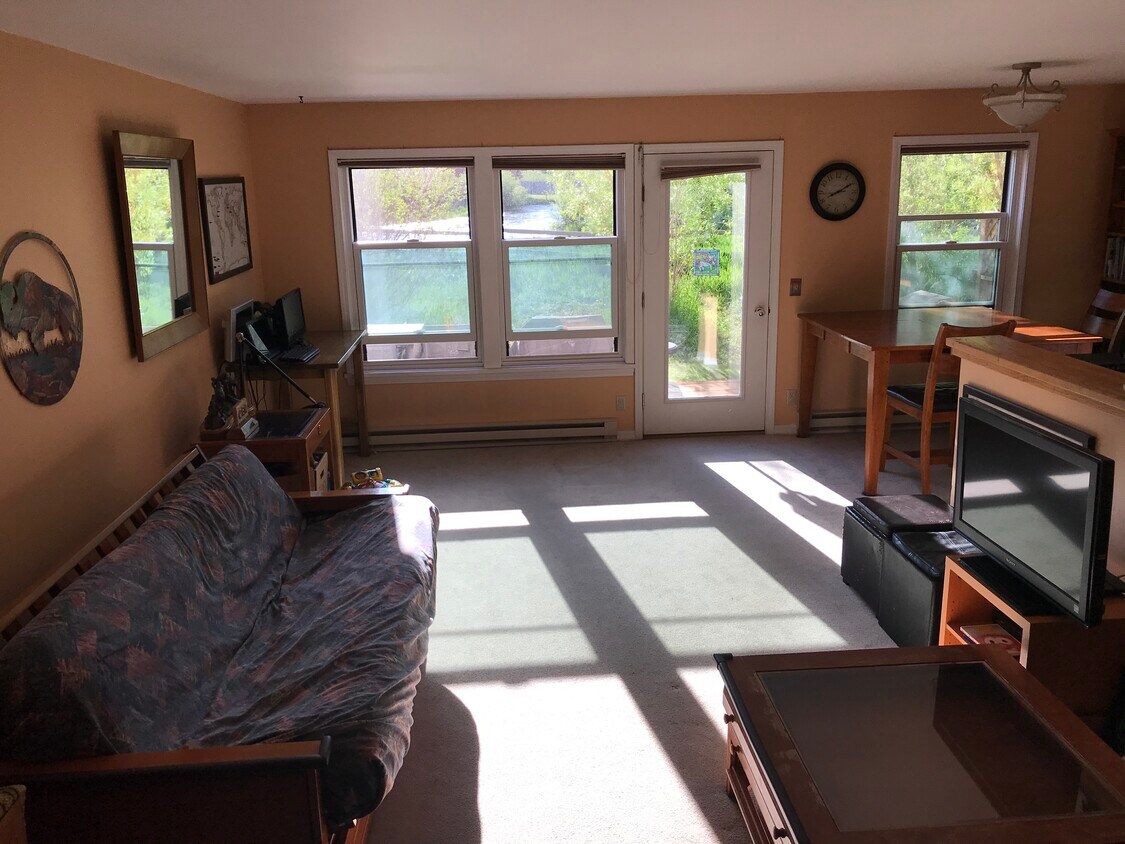 Bright, open living room w/view of Flat Creek - 1070 Elk Run Ln