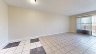 Located at 400 Baker St in Placentia, CA, this single-floor residence offers a practical and comfortable layout with two bedrooms and two full bathrooms. The living room features light-toned tile flooring in a classic grid pattern and connects seamlessly to the dining area, creating an open, airy feel. A sliding glass door with vertical blinds leads to a private balcony, allowing natural light to pour into the space and offering outdoor views. The kitchen is equipped with white cabinetry, tile countertops, a built-in sink, and a two-tone tile floor accented with darker inset squares, adding visual interest to the space. Both bedrooms are carpeted in warm neutral tones and feature sliding-door closets with built-in rods for ample storage. The primary bedroom is comfortably sized and benefits from a window with natural light. Each bathroom includes a full tub-shower combination, a toilet, and tile flooring; one bathroom additionally features a vanity with white cabinetry and a large mirror. Textured ceilings are consistent throughout the home, contributing to its classic character. Hallways connect the living spaces to the bedrooms and bathrooms, providing a well-organized and efficient flow throughout this cozy Placentia residence.