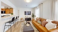 Located at 1335 Dreibelbis St in State College, PA, this two-story home offers 3 bedrooms and 4 bathrooms across two well-designed floors. The main level welcomes you through a dedicated entrance that opens into a bright, open-concept living and kitchen area. The living room features light hardwood-style flooring, large windows dressed with sheer curtains that fill the space with natural light, and a wall-mounted TV. A breakfast bar with sleek black stools connects seamlessly to the kitchen, which is outfitted with warm wood cabinetry, stainless steel appliances including a refrigerator, dishwasher, microwave, and range, plus tile flooring and ample counter space. A laundry area and multiple closets add everyday convenience on this floor. The upper level hosts all three bedrooms, including a generously sized primary bedroom with carpeted flooring and a bright window with outdoor views. The additional bedrooms are equally well-appointed, each with natural light, carpet, and open closet storage. Four clean, tile-floored bathrooms with wood vanities are distributed throughout both floors to ensure comfort and privacy. A staircase connects the two levels, completing this functional and well-laid-out home.