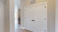 This well-designed 830 square foot apartment offers a perfect blend of comfort and style. The single-level layout comprises one bedroom, two bathrooms, and an open-concept living area. The primary bedroom, measuring 190 square feet, provides ample space for relaxation and storage.

The apartment's most striking feature is its abundance of natural light, courtesy of multiple large windows that span from floor to ceiling. These windows not only brighten the space but also offer panoramic views of the surrounding cityscape, creating an airy and expansive feel.

The living area boasts a modern aesthetic with neutral-toned walls and light wood-look flooring, which contributes to the overall sense of spaciousness. A contemporary ceiling fan with integrated lighting adds both functionality and style to the room.

The open floor plan seamlessly integrates the living room, dining area, and kitchen, making it ideal for entertaining or everyday living. While not visible in the image, the presence of two bathrooms adds convenience and luxury to this compact yet well-appointed urban dwelling.