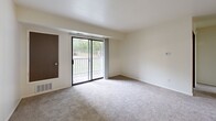 Located at 1630 Leonard St NE in Grand Rapids, Michigan, this one-bedroom, one-bathroom unit offers a functional and efficient single-floor layout. The living room serves as the heart of the space, featuring neutral-toned carpet, light-colored walls, and a sliding glass door that opens to a private balcony overlooking a treed outdoor setting, allowing natural light to fill the room. The galley-style kitchen is thoughtfully arranged with dark wood cabinetry, light countertops, tile flooring, and white appliances including a refrigerator, stove, and dishwasher, providing ample storage and workspace within a compact footprint. The bedroom is a comfortable, carpeted retreat with a window fitted with blinds that offers natural light and outdoor views, along with a dedicated closet for storage. The bathroom features a clean, classic design with a tub and shower combination, a white vanity with storage, tile flooring, and a well-lit mirror above the sink. Throughout the unit, a consistent neutral color palette and carpeted living areas create a cohesive, calm ambiance. The layout is efficient and well-suited for everyday living in a convenient Grand Rapids neighborhood.