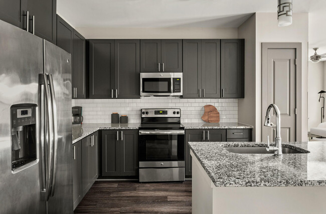 Experience culinary excellence in this contemporary kitchen, where style meets functionality. - The Sawyer at One Bellevue Place