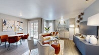 This thoughtfully designed 3-bedroom, 2-bathroom residence offers a cohesive single-floor layout that maximizes functionality and comfort. The open-concept living and dining area serves as the heart of the home, featuring warm hardwood-style flooring, neutral gray walls, and large sliding glass doors and windows that flood the space with natural light. A built-in display niche with gold accent lighting adds a decorative focal point to the living room, which flows seamlessly into a dedicated dining area.

The kitchen is equipped with stainless steel appliances, including a refrigerator and electric range, complemented by granite countertops, white cabinetry with modern hardware, and a herringbone tile backsplash. A breakfast bar provides additional seating and casual dining options.

The primary bedroom offers a comfortable, carpeted retreat with windows overlooking the exterior and ample space for a sitting area. The additional bedrooms share a similar warm aesthetic with plush carpet and natural light.

Both bathrooms are finished with granite vanity countertops, white cabinetry, wood-style flooring, and tub-shower combinations with full tile surrounds. A utility area with washer/dryer connections adds everyday convenience. The overall ambiance throughout is modern yet welcoming, with consistent, tasteful finishes.