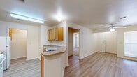 Located at 8301 Tumbleweed Trail in White Settlement, TX, this single-story, one-bedroom, one-bathroom home offers a well-designed layout that maximizes every inch of its compact footprint. Light-toned luxury vinyl plank flooring runs throughout the main living areas, lending a clean and cohesive look to the space.

The open-concept living, dining, and kitchen area forms the heart of the home. The kitchen is equipped with warm honey-toned wood cabinetry, a white refrigerator, a white range, and a dishwasher, all complemented by neutral countertops. A peninsula with a breakfast bar provides a natural transition into the dining and living areas, which are bright and airy, featuring a ceiling fan with light fixture and a window that admits natural light.

The bedroom offers plush carpet flooring and its own ceiling fan, creating a comfortable retreat. Two six-panel doors lead to separate closet spaces, providing generous storage. A dedicated pantry and in-unit laundry area add practical convenience.

The bathroom features warm wood cabinetry, a wide vanity with ample counter space, overhead cabinetry for storage, and hard flooring for easy maintenance. A hallway connects the bedroom and bathroom to the main living areas, ensuring a functional flow throughout the home.