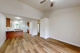 Located at 5209 Old Redwood in Wikiup, CA, this well-appointed 2-bedroom, 2-bathroom residence offers a comfortable and functional single-floor layout. The open-concept living area features light hardwood-style flooring throughout, vaulted ceilings with a ceiling fan, and a large window that fills the space with natural light and offers views of the surrounding greenery.

The kitchen is a standout feature, equipped with rich warm-toned wood cabinetry, white quartz-style countertops, a peninsula breakfast bar, and white appliances including an electric range, dishwasher, and refrigerator. Ample upper and lower cabinet storage makes the kitchen as practical as it is attractive.

Both bedrooms are bright and well-sized, with the primary bedroom offering generous proportions, large windows with vertical blinds, and direct access to a closet. The second bedroom is equally comfortable with natural light and wood-style flooring. Four closets throughout the unit provide abundant storage.

The two bathrooms are clean and efficiently designed, each featuring wood-toned vanities with white countertops, a tub/shower combination, and hardwood-style flooring. Additional highlights include a hallway connecting all rooms, a utility room, and a balcony for outdoor enjoyment. Textured ceilings and neutral wall tones complete the cohesive, move-in-ready aesthetic.