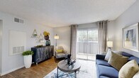 Located at 12801 Roydon Dr in Houston, TX, this single-floor, one-bedroom, two-bathroom home offers a thoughtfully arranged layout across a comfortable footprint. The living room serves as the central gathering space, featuring wood-style flooring, a textured ceiling, and a large sliding glass door flanked by vertical blinds that flood the room with natural light and provide direct access to the private patio. A dedicated dining area with wainscoting detail and a window adds a refined touch to the open flow between spaces. The kitchen is well-appointed with white cabinetry, light countertops, and black appliances, including a full-size refrigerator and dishwasher, all set atop matching wood-style flooring. The bedroom is a comfortable retreat with plush carpet, a ceiling fan, natural light from a window with blinds, and access to a dedicated closet. Two bathrooms serve the home — one featuring a wide vanity with white cabinetry, a large mirror, and wood-style flooring, and the other offering a full tub-shower combination with clean white tile surround. An in-unit laundry area adds everyday convenience. The patio extends the living space outdoors, rounding out this efficiently designed Houston home.