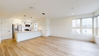 Located at 10719 Cedar Ave in Cleveland's 44106 zip code, this modern three-bedroom, three-bathroom home spans three thoughtfully designed floors. The ground level houses a garage with an automatic opener and utility space, providing practical storage and parking. The main living floor features an open-concept layout with light hardwood flooring throughout. The kitchen is a standout, boasting white cabinetry, stainless steel appliances, a built-in microwave, and a large peninsula with a warm countertop surface accented by sleek pendant lighting. The adjoining living area is bright and airy, benefiting from multiple windows that invite generous natural light. A pantry and laundry room add everyday convenience on this level. The upper floor hosts the three bedrooms, including a well-proportioned primary bedroom, along with closets and additional bathrooms. Bedrooms feature large windows with neighborhood views and continue the light hardwood flooring found throughout the home. Bathrooms are finished with white vanities, neutral countertops, and matte black hardware that echoes the consistent modern detailing found in door knobs and hinges across the home. A balcony and bonus room round out the offerings, while multiple staircases connect the floors efficiently. The overall aesthetic is clean, contemporary, and move-in ready.
