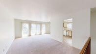 This two-bedroom, one-bathroom residence in Lapeer, Michigan presents a practical and well-organized single-floor layout. The expansive living area is a standout feature, with soft carpeting underfoot and a wall of sliding glass doors dressed in vertical blinds that flood the room with natural light and provide access to the outdoors. A pass-through opening connects the living space to the kitchen, which is equipped with wood-trimmed cabinetry, a double sink, a dishwasher, an electric range, a full-size refrigerator, and tile flooring. A window above the sink brings in additional natural light. Adjacent to the kitchen is a dedicated dining room, keeping daily routines well-organized. The primary bedroom offers a generous footprint with plush carpeting, a large window overlooking greenery, and a wide double-door closet providing ample storage. The second bedroom is equally well-lit and carpeted, with a separate closet for added convenience. A dedicated laundry room and additional closet space round out the functional amenities of this home. Throughout, the neutral color palette and clean lines create a calm, move-in-ready environment suitable for a variety of lifestyles.