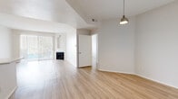 Located at 11615 Firestone Blvd in Norwalk, CA, this single-story, 2-bedroom, 2-bathroom home offers a well-organized layout across a comfortably sized floor plan. Light wood-style flooring runs throughout, creating a cohesive and clean aesthetic in every room.

The open living area is highlighted by vaulted ceilings that enhance the sense of space, a classic fireplace as a focal point, and sliding glass doors fitted with vertical blinds that invite natural light. A pendant light fixture adds a modern touch to the adjoining dining area.

The kitchen is outfitted with white shaker-style cabinetry, a white subway tile backsplash, and stainless steel appliances including a gas range, over-the-range microwave, and a refrigerator — providing both style and function.

Both bedrooms feature the same light wood flooring, neutral walls, and windows with blinds that allow for ample natural light and outdoor views. The spacious primary bedroom offers generous proportions well-suited for comfortable living.

Each bathroom is finished with white cabinetry, a vanity with mirror, and a shower-tub combination. The overall design emphasizes a clean, neutral palette throughout, making the space feel bright, airy, and move-in ready.