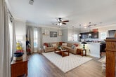 Located at 2300 Cottage Ln in College Station, TX, this two-story home offers five bedrooms and five bathrooms across two well-proportioned floors. The main level is anchored by an open-concept living room and kitchen combination, where hardwood-style flooring, crown molding, and a ceiling fan create a warm and inviting atmosphere. The kitchen is outfitted with dark cabinetry, dark granite countertops, stainless steel appliances, and a breakfast bar with pendant lighting overhead — making it both functional and stylish. A dedicated hallway and staircase connect the floors, providing an organized flow throughout the home. Each of the five bedrooms features plush carpeting, natural light from windows with outdoor views, and direct access to a private closet. The ensuite bathrooms are finished with tile flooring, dark wood vanities, and tub-shower combinations, offering comfort and privacy for every occupant. A dedicated laundry area with a stacked washer and dryer adds everyday convenience. The upper floor mirrors the layout of the lower level, maximizing usable space across the home. Neutral tones and consistent finishes throughout lend the home a cohesive and well-maintained feel.
