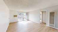 Located at 37945 30th St E in Palmdale, CA, this single-floor home offers four bedrooms and two bathrooms within a well-organized layout. The bright, open living room features light wood laminate flooring, a textured ceiling, a wall-mounted AC unit, and a sliding glass door that opens to a private balcony, filling the space with natural light and outdoor views. The kitchen is designed for efficiency, with a galley-style layout, white cabinetry, granite-style countertops, a gas range, and a pass-through bar counter that connects to the living area. Each bedroom is finished with the same light wood flooring, ceiling fans with light fixtures, and generous sliding-door closets offering ample storage. Bedrooms benefit from natural light through sizeable windows with exterior views. Both bathrooms are clean and functional, featuring granite-topped vanities, large mirrors, and light wood flooring. One bathroom includes a bathtub. A connecting hallway ties all rooms together, creating a cohesive and practical flow throughout the home. The consistent neutral color palette and light finishes throughout contribute to a bright, airy ambiance well-suited to the sunny Palmdale climate.