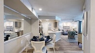 This thoughtfully designed 2-bedroom, 3-bathroom single-floor residence offers a comfortable and stylish living experience. The open-concept layout seamlessly connects the dining room, kitchen, and living room, creating a fluid and sociable space ideal for everyday living and entertaining. The kitchen is equipped with stainless steel appliances, including a refrigerator, range, and microwave, complemented by sleek grey cabinetry, a subway tile backsplash, and a curved quartz countertop peninsula that doubles as a breakfast bar. Wood-look flooring runs throughout the main living areas, adding warmth and cohesion to the space. The living room is bright and inviting, featuring recessed lighting and a ceiling fan. The dining area includes a large mirror accent wall that enhances the sense of space. A sun-filled nook with large windows serves as a versatile flex space, ideal as a home office or reading area. Both bedrooms are comfortably sized, each featuring ceiling fans, natural light from windows with exterior views, and wood-look flooring. The primary bedroom offers a peaceful retreat. The three bathrooms are finished with quartz countertops, grey vanity cabinetry, large mirrors, and contemporary light fixtures. A dedicated closet provides additional storage.