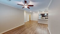 Located at 5221 Old Hixson Pike in Chattanooga, Tennessee, this single-floor unit offers a well-designed, open-concept layout that seamlessly connects the living area to the kitchen. The living space features warm hardwood-style flooring, crown molding, recessed lighting, and a ceiling fan with light fixture, creating a bright and welcoming atmosphere.

The kitchen is a standout feature, showcasing rich dark cabinetry that extends to the ceiling, light granite countertops with a tile backsplash, and a full suite of stainless steel appliances including a refrigerator, range, and built-in microwave. Pendant lighting over the kitchen island adds a refined touch.

The bedrooms are carpeted for comfort and each includes a ceiling fan. Natural light filters in through blinds-covered windows, contributing to a calm and restful ambiance. The bathrooms are finished with the same dark cabinetry and granite vanity tops found in the kitchen, maintaining a consistent design language throughout. Each bathroom includes a tub-shower combination and hardwood-style flooring.

Overall, the unit presents a cohesive, modern interior with neutral tones, quality finishes, and a functional floor plan well-suited for everyday living in the Chattanooga area.