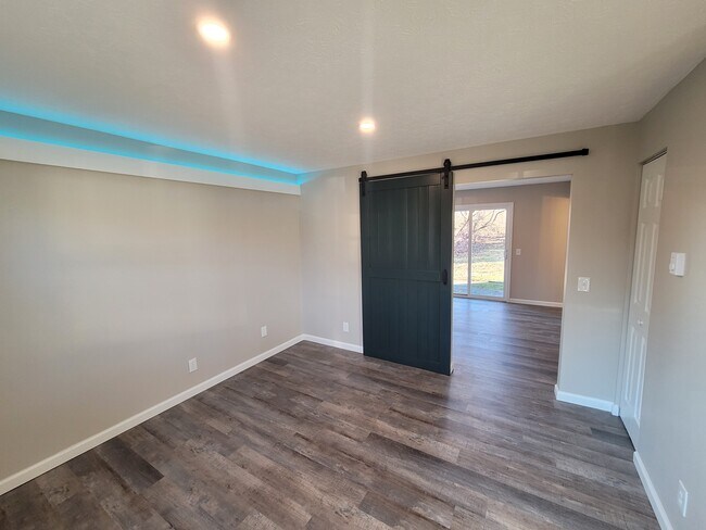 FAMILY ROOM - ACCENT LIGHTING, LED CAN LIGHTING, BARN DOOR, LUXURY VINYL PLANK FLOORING - 4637 Tioga St NW