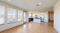 Located at 4000 Dr Walter S Davis Blvd in Nashville, TN, this well-appointed 3-bedroom, 2-bathroom single-floor home offers a clean, modern design with thoughtful finishes throughout. The open-concept living, dining, and kitchen area serves as the heart of the home, featuring light hardwood-style flooring, recessed lighting, and large windows that flood the space with natural light and offer views of the surrounding neighborhood. The kitchen is equipped with stainless steel appliances, a center island, dark quartz countertops, two-tone cabinetry with white upper cabinets and gray lower cabinets, and a subway tile backsplash. The three bedrooms are comfortably sized, with the primary bedroom offering particularly generous proportions. Bedrooms feature plush carpet flooring and large windows. The bathrooms are finished with white cabinetry, dark countertops, and clean tile work. A dedicated laundry room includes an in-unit washer and dryer. Additional features include five closets, a utility room, a hallway, and a welcoming entrance. The home presents a bright, neutral palette throughout, creating a fresh and move-in ready atmosphere.