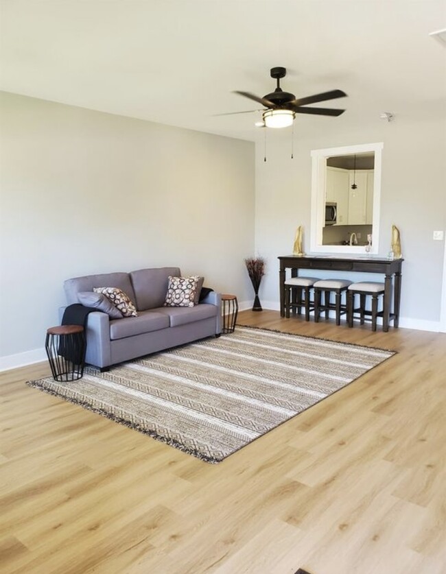 Spacious living room with luxury vinyl plank floors - 140 Sunburst Villa Dr