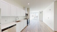 Located at 1720 Research Park Dr in Davis, CA, this thoughtfully designed one-bedroom, one-bathroom unit offers a clean, contemporary aesthetic across a single floor. Light hardwood-style flooring flows seamlessly throughout the entire space, complementing the bright, white interior palette.

The open-concept kitchen and living area forms the heart of the unit. The kitchen is outfitted with white shaker-style cabinetry extending to the ceiling for ample storage, a subway tile backsplash, light quartz countertops, and a full suite of stainless steel appliances including a refrigerator, electric range, built-in microwave, and dishwasher. The kitchen opens directly into the living area, which is bathed in natural light from large windows overlooking the surrounding community.

The bedroom is a well-proportioned retreat featuring large windows that invite generous daylight and neighborhood views, along with a dedicated closet for storage. The bathroom is finished with white shaker cabinetry, a dark countertop vanity with an undermount sink, a full soaking tub with shower, and matching light flooring. The entryway provides a clean transition into the unit with a modern keypad entry door and an adjacent closet. The overall ambiance is bright, minimal, and move-in ready.