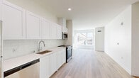 Located at 1720 Research Park Dr in Davis, CA, this thoughtfully designed one-bedroom, one-bathroom unit offers a clean, contemporary aesthetic across a single floor. Light hardwood-style flooring flows seamlessly throughout the entire space, complementing the bright, white interior palette.

The open-concept kitchen and living area forms the heart of the unit. The kitchen is outfitted with white shaker-style cabinetry extending to the ceiling for ample storage, a subway tile backsplash, light quartz countertops, and a full suite of stainless steel appliances including a refrigerator, electric range, built-in microwave, and dishwasher. The kitchen opens directly into the living area, which is bathed in natural light from large windows overlooking the surrounding community.

The bedroom is a well-proportioned retreat featuring large windows that invite generous daylight and neighborhood views, along with a dedicated closet for storage. The bathroom is finished with white shaker cabinetry, a dark countertop vanity with an undermount sink, a full soaking tub with shower, and matching light flooring. The entryway provides a clean transition into the unit with a modern keypad entry door and an adjacent closet. The overall ambiance is bright, minimal, and move-in ready.