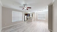 Located at 10498 Fountain Lake Drive in Stafford, Texas, this single-story home offers a well-organized layout with three bedrooms, two bathrooms, an attached garage, and a dedicated laundry room. The open-concept living and kitchen area forms the heart of the home, where light wood-style flooring, a ceiling fan with integrated lighting, and multiple windows with white blinds create a bright, airy atmosphere. Track lighting accents the space, adding functional versatility.

The kitchen is outfitted with rich dark-espresso cabinetry, light quartz-style countertops, a subway tile backsplash, and a full suite of stainless steel appliances, including a refrigerator, range, microwave, and dishwasher. A peninsula provides additional prep and serving space that flows naturally into the living area.

The bedrooms feature soft carpet flooring, ceiling fans, and windows that bring in natural light. The primary bedroom includes access to a bathroom with dark-framed mirrors, a vanity with light countertops, and dark cabinetry. Two closets offer wire shelving for organized storage. The laundry room houses a full-size washer and dryer alongside additional shelving. The attached garage provides an automatic opener and ample room for parking and storage.