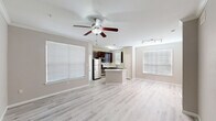 Located at 10498 Fountain Lake Drive in Stafford, Texas, this single-story home offers a well-organized layout with three bedrooms, two bathrooms, an attached garage, and a dedicated laundry room. The open-concept living and kitchen area forms the heart of the home, where light wood-style flooring, a ceiling fan with integrated lighting, and multiple windows with white blinds create a bright, airy atmosphere. Track lighting accents the space, adding functional versatility.

The kitchen is outfitted with rich dark-espresso cabinetry, light quartz-style countertops, a subway tile backsplash, and a full suite of stainless steel appliances, including a refrigerator, range, microwave, and dishwasher. A peninsula provides additional prep and serving space that flows naturally into the living area.

The bedrooms feature soft carpet flooring, ceiling fans, and windows that bring in natural light. The primary bedroom includes access to a bathroom with dark-framed mirrors, a vanity with light countertops, and dark cabinetry. Two closets offer wire shelving for organized storage. The laundry room houses a full-size washer and dryer alongside additional shelving. The attached garage provides an automatic opener and ample room for parking and storage.