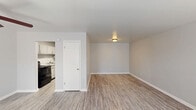 Located at 1800 Augusta Ct in Lexington, Kentucky, this efficient single-floor unit offers a well-organized layout comprising a living room, kitchen, bathroom, and closet. The living room is bright and open, finished with light wood-look vinyl plank flooring and neutral gray walls that create a clean, modern aesthetic. A front entry door with a window allows natural light to filter in, and a flush-mount ceiling fixture provides overhead illumination. An electrical panel is conveniently accessible within the living area. The kitchen is thoughtfully equipped with white cabinetry, granite-patterned countertops, a double-basin stainless steel sink, and a black electric coil range, offering a functional space for everyday cooking. The closet features wire shelving and a hanging rod, providing practical storage solutions. The bathroom includes a full tub and shower combination with a white surround, chrome fixtures, and built-in recessed shelving for added convenience. Consistent light vinyl plank flooring and crisp white trim run throughout the space, tying each room together with a cohesive, updated look. Clean lines and a neutral palette make this unit a versatile and move-in-ready home in Lexington.