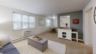 Located at 2981 Olentangy River Road in Columbus, Ohio, this one-bedroom, one-bathroom residence offers a practical and well-organized single-floor layout. The living area serves as the heart of the unit, featuring neutral-toned carpet flooring, a window with natural light, and wall-unit climate control. The space flows naturally into a dedicated dining area, which benefits from multiple windows that fill the room with daylight and overlook greenery outside. A compact kitchen sits adjacent to the dining space, equipped with white cabinetry, a white appliance suite including a stove and refrigerator, and a double-basin sink — providing efficient functionality in a modest footprint. The bedroom is a quiet, carpeted retreat featuring a window with outdoor views, a wall-unit air conditioner, and clean white walls that create a calm atmosphere. The bathroom retains a vintage character with warm-toned ceramic tile, a full soaking tub with shower, a frosted privacy window, and a pedestal-style sink. A connecting hallway ties the rooms together with ease. Overall, the unit presents a straightforward, functional living environment well-suited for individuals seeking proximity to Columbus amenities.