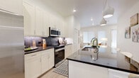 Located at 3390 28th St in Boulder, Colorado, this contemporary multi-floor residence offers a thoughtfully designed layout spread across three levels. The ground floor houses a garage equipped with an EV charger and a utility room, providing practical convenience from the moment you arrive. Light wood-look flooring and clean white walls establish a cohesive, modern aesthetic throughout.

The main living level serves as the heart of the home, featuring an open-concept kitchen, dining room, and living room bathed in natural light from large windows. The kitchen is a standout space, outfitted with crisp white shaker cabinetry, dark granite countertops, a tile backsplash, stainless steel appliances, and a spacious island with pendant lighting and seating — ideal for both cooking and casual entertaining. A pantry adds generous storage nearby.

The upper floor is home to two bedrooms, including a primary suite with a walk-in closet featuring built-in shelving and a private en-suite bathroom. A dedicated office provides a quiet workspace, while the in-unit laundry and multiple well-appointed closets enhance everyday functionality. Three full bathrooms are finished with clean lines and warm wood-tone flooring. A balcony offers an outdoor retreat, and three staircases connect the floors with ease. This residence combines modern design with practical Boulder living.