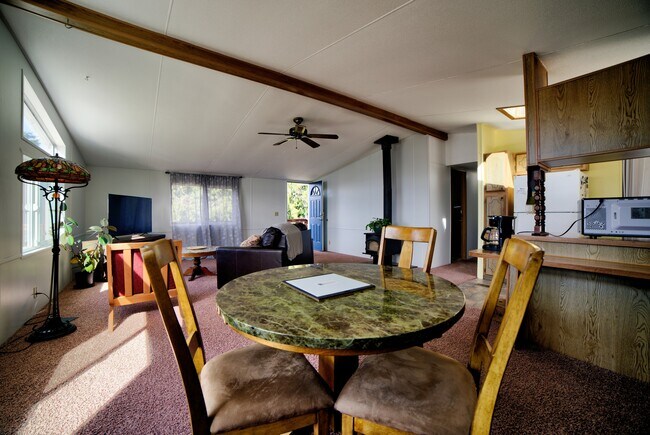 Dining room is next to living room, four person table. - 5170 W Shore Rd