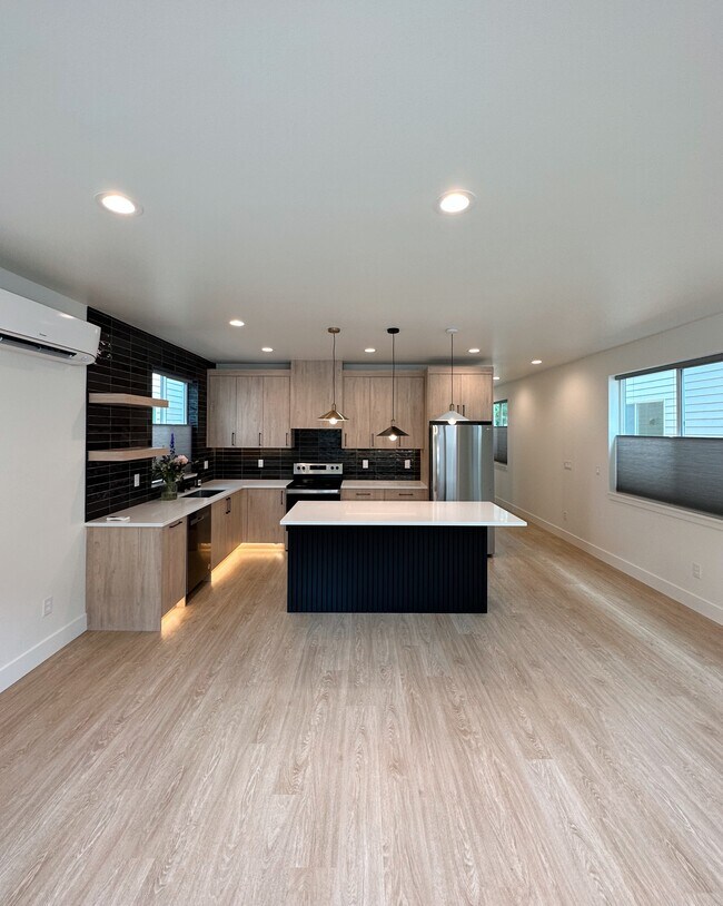 Open floor plan with hardwood style throughout - 1220 W 24th St