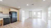 Located on 3rd St SW in Kasson, Minnesota, this well-designed two-bedroom, two-bathroom residence offers a thoughtfully laid-out single-level floor plan with a clean, modern aesthetic throughout. Light wood luxury vinyl plank flooring runs continuously through every room, contributing to a bright and cohesive atmosphere.

The open-concept kitchen and living area serves as the heart of the home. The kitchen is outfitted with light maple cabinetry, granite-style countertops, and black appliances including a refrigerator, range, microwave, and dishwasher. Recessed lighting illuminates the space efficiently.

The living area flows naturally toward a glass-paned door that opens onto a private balcony, where a sidelight window allows additional natural light to fill the room and offers outdoor views of the surrounding landscape.

Both bedrooms are generously sized with large windows that frame open, natural views, filling each room with ample daylight. Three closets provide convenient storage throughout the unit.

The two bathrooms feature light maple vanities with granite-style countertops. One bathroom includes a walk-in shower with clean white surrounds. A dedicated utility room houses a full-size side-by-side washer and dryer, adding everyday convenience. The overall design is clean, neutral, and move-in ready.