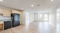 Located on 3rd St SW in Kasson, Minnesota, this well-designed two-bedroom, two-bathroom residence offers a thoughtfully laid-out single-level floor plan with a clean, modern aesthetic throughout. Light wood luxury vinyl plank flooring runs continuously through every room, contributing to a bright and cohesive atmosphere.

The open-concept kitchen and living area serves as the heart of the home. The kitchen is outfitted with light maple cabinetry, granite-style countertops, and black appliances including a refrigerator, range, microwave, and dishwasher. Recessed lighting illuminates the space efficiently.

The living area flows naturally toward a glass-paned door that opens onto a private balcony, where a sidelight window allows additional natural light to fill the room and offers outdoor views of the surrounding landscape.

Both bedrooms are generously sized with large windows that frame open, natural views, filling each room with ample daylight. Three closets provide convenient storage throughout the unit.

The two bathrooms feature light maple vanities with granite-style countertops. One bathroom includes a walk-in shower with clean white surrounds. A dedicated utility room houses a full-size side-by-side washer and dryer, adding everyday convenience. The overall design is clean, neutral, and move-in ready.