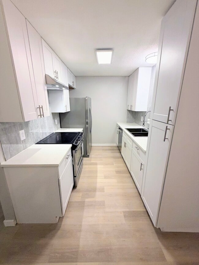 Kitchen with lots of storage space, quartz countertops, stainless steel appliances - 7501 April Ln