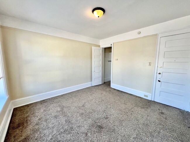 Step into this bright and airy bedroom, offering comfort and style. - Cross Apartments