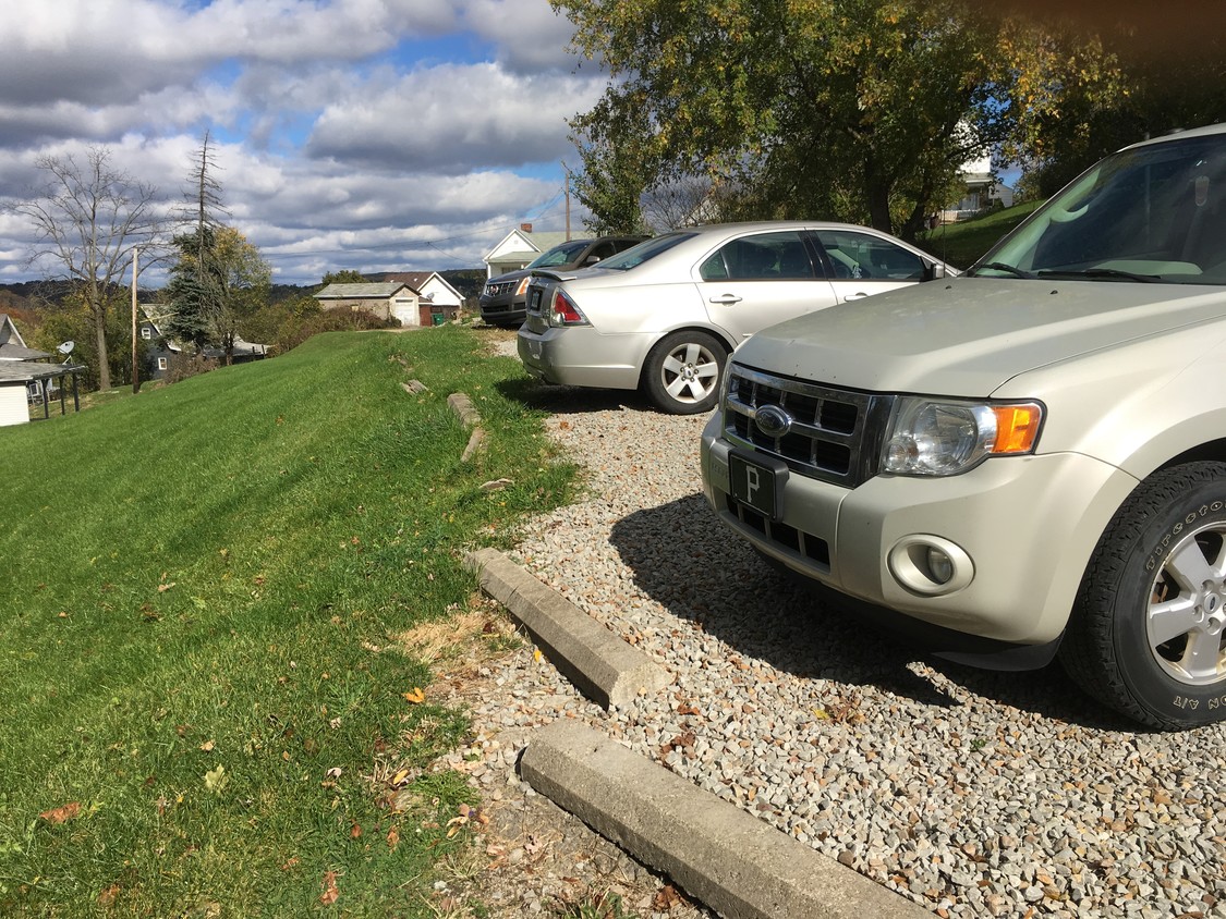 Parking lot in rear adjacent to sidewalk - 450 Henderson Ave