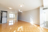 Located at 65 Times Ave in Markham, Ontario, this single-floor unit offers a clean, well-organized layout comprising a living room, kitchen, bathroom, and laundry area. The living room is a standout space, featuring gleaming parquet hardwood flooring that reflects generous natural light streaming in through a large window dressed with vertical blinds. Neutral grey walls and flush-mount ceiling fixtures contribute to a bright, open atmosphere. The kitchen is efficiently designed in a galley-style configuration, outfitted with white cabinetry extending to the ceiling for ample storage, a stainless steel sink, a dishwasher, and a full-size refrigerator. Light tile flooring and a white backsplash keep the space clean and cohesive. The bathroom is finished with beige tile flooring and a tub-shower surround, complemented by a white vanity with under-sink storage and a well-placed mirror with overhead lighting. A dedicated laundry area with stacked units adds practical convenience. Throughout the unit, white trim and consistent neutral tones create a cohesive, move-in-ready aesthetic that is both functional and welcoming.