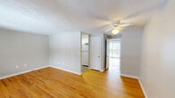 Located at 144 Pinney St in Ellington, CT, this well-maintained single-floor unit offers a functional and comfortable layout. Warm hardwood flooring flows throughout the main living areas, complemented by neutral-toned walls and textured ceilings that lend a classic character to the space. The living room is bright and inviting, featuring a ceiling fan with a light fixture, a front entry door with sidelights, and large windows fitted with blinds that allow natural light to fill the room. A sliding glass door with vertical blinds opens to an outdoor view, further brightening the space. Baseboard heating is present throughout, ensuring year-round comfort. The kitchen is efficiently designed with white cabinetry, stone-patterned countertops, a stainless steel sink, and light wood-look flooring, offering practical storage and workspace. The bedroom is generously proportioned and served by two closets, providing ample storage. The bathroom is clean and straightforward, featuring a tiled tub-shower combination with a showerhead, a single vanity, and a mirror. Two additional closets throughout the unit offer versatile storage options, rounding out this practical and comfortable Ellington residence.
