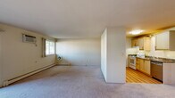 Located at 3134 Greenfield Rd in Royal Oak, Michigan, this one-bedroom, one-bathroom residence offers a comfortable and functional single-floor layout. The expansive living room is carpeted and bathed in natural light from large windows, with baseboard heating and a wall-mounted air conditioning unit ensuring year-round comfort. The space flows seamlessly into a dedicated dining area, creating an open and inviting atmosphere.

The kitchen features light maple cabinetry, granite-style countertops, hardwood-style flooring, a full suite of appliances including a refrigerator, electric range, and dishwasher, and a pendant light fixture overhead. An adjacent pantry provides convenient additional storage.

The well-sized bedroom is carpeted and includes its own window for natural light, baseboard heating, and a ventilation unit. Three closets throughout the unit — including generously shelved options — offer excellent storage capacity. The bathroom is finished with classic white subway tile surrounding the tub and shower, a granite-top vanity, and tile flooring, lending a clean, timeless aesthetic.

A private balcony extends the living space outdoors, and a hallway ties the layout together efficiently. This residence combines practical design with comfortable living in a well-connected Royal Oak location.