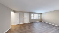 Located on W Bryn Mawr Ave in Chicago's Norwood Park neighborhood, this well-appointed unit offers a thoughtfully designed single-floor layout. The living room is bright and welcoming, featuring warm hardwood-style flooring, neutral gray walls, clean white trim, and a large window that invites ample natural light. A dedicated entry door adds a sense of privacy and arrival to the space.

The kitchen is a standout feature, outfitted with modern two-tone cabinetry, crisp white quartz countertops, and a classic white subway tile backsplash. Stainless steel appliances — including a full-size refrigerator, gas range, built-in microwave, and dishwasher — complete the functional and stylish cooking space. Light wood-style flooring carries throughout, creating a cohesive aesthetic.

An additional room off the living area provides flexible use as a bedroom or office, with access to a walk-in closet offering generous built-in storage. A second closet near the entryway adds further organizational convenience.

The bathroom is finished with white subway tile surrounding a full soaking tub and shower, complemented by a glass block window for privacy and natural light, a white vanity, and wood-style flooring. The overall design is clean, modern, and move-in ready.
