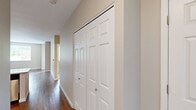 Located in Happy Valley, Oregon, this 2-bedroom, 2-bathroom apartment offers a thoughtfully designed single-floor layout with a blend of modern finishes and practical living spaces. The kitchen is a standout feature, showcasing rich dark-wood cabinetry, granite-style countertops, a peninsula breakfast bar, and a full suite of stainless steel appliances including a refrigerator, range, microwave, and dishwasher. Track lighting overhead adds a contemporary touch. The kitchen opens directly to the living area, which features warm hardwood-style flooring and a window that brings in natural light and outdoor views. Both bedrooms are carpeted for comfort and include windows with outdoor views and closet space. The primary bedroom is complemented by a private en-suite bathroom featuring a granite-topped vanity with dark wood cabinetry, a large mirror, and stylish lighting fixtures. The second bathroom offers a full tub-shower combination with clean white finishes and matching hardwood-style flooring. Neutral warm-toned walls throughout the unit create a cohesive and inviting atmosphere, while ceiling fans in the bedrooms add both function and comfort to the space.