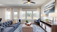 Located in the Highland Creek community of Charlotte, NC, this single-floor residence offers a thoughtfully designed open-concept layout with a cohesive, contemporary aesthetic throughout. The kitchen is well-appointed with dark espresso cabinetry, granite countertops, a central island with a stainless steel sink, and a full suite of stainless steel appliances, including a side-by-side refrigerator, range, microwave, and dishwasher. Warm wood-look flooring extends seamlessly through the kitchen, dining, and living areas. The dining space accommodates comfortable seating and is accented by arched decorative mirrors on the wall. The expansive living room features a ceiling fan, large windows that flood the space with natural light, and direct access to an outdoor balcony with green views. The bedroom is a tranquil retreat with plush carpeting, generous natural light from a large window overlooking the outdoors, and a spacious walk-in closet with multi-tiered shelving. The bathroom includes a glass-enclosed walk-in shower, wood-look flooring, granite vanity, and open shelving. Neutral wall tones and clean architectural lines create a bright, welcoming ambiance throughout the entire residence.