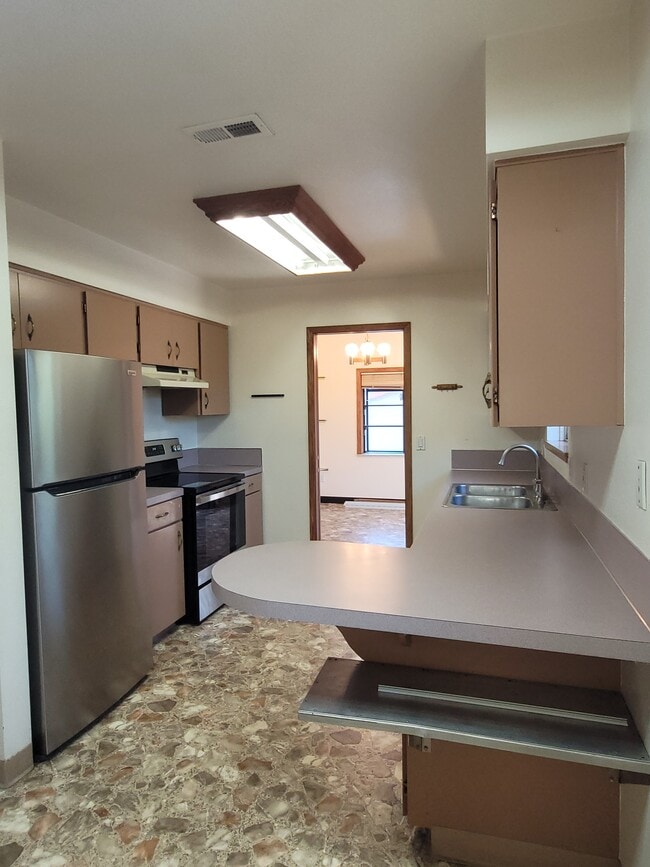 kitchen with stainless steel appliances and high arch faucet - 5095 SW 163rd Ave