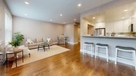 Located in Hackensack, NJ, this well-appointed 2-bedroom, 2-bathroom residence is thoughtfully designed across a single floor. The open-concept kitchen and living area serves as the heart of the home, where the kitchen impresses with crisp white shaker cabinetry, granite countertops, a gray subway tile backsplash, and a full suite of stainless steel appliances including a refrigerator, range, microwave, and dishwasher. Light tile flooring completes the kitchen's clean, modern aesthetic. The adjoining living room offers rich hardwood flooring, recessed lighting, and a bright window with views of mature greenery, creating an inviting, comfortable atmosphere. The spacious primary bedroom features dual windows that flood the room with natural light, hardwood floors, a ceiling fan, and a wall-mounted HVAC unit. The second bedroom is equally comfortable, also finished with hardwood floors and a window overlooking the neighborhood. Both bathrooms are finished with large-format tile flooring, dark espresso vanities with white countertops, and tub-shower combinations with tile surrounds. A connecting hallway ties the layout together efficiently, offering a cohesive and functional flow throughout this well-maintained Hackensack residence.