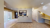 Located at 10770 W Florence Dr in Boise, Idaho, this two-floor residence offers a well-designed layout with functional and attractive finishes throughout. The main living area is open and inviting, featuring plush wall-to-wall carpeting and a seamless flow into the kitchen via a pass-through breakfast bar with granite countertops and corbel supports — ideal for casual dining or entertaining. The kitchen is well-appointed with rich dark wood cabinetry, granite countertops, tile flooring, and a full suite of black appliances including an electric range, built-in microwave, and refrigerator. Track lighting illuminates the space, complemented by pendant lights over the bar area. Bedrooms are carpeted and generously sized, with windows that allow natural light to fill the rooms. Closets feature sliding panel doors with built-in rods for organized storage. Bathrooms include tile flooring, dark wood vanities, and a clean white tub-shower combination. A programmable thermostat is conveniently located in the main living area. The overall design balances neutral tones with warm finishes, creating a cohesive and comfortable living environment across both floors.