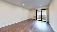 Located at 510 S Normandie Ave in the heart of Los Angeles, this efficiently designed single-floor unit offers a thoughtful layout across a cozy, well-utilized footprint. The space comprises a combined kitchen and living room, a separate living room, a hallway, and a full bathroom — all connected in a clean, functional flow.

The living areas are finished with rich, warm hardwood-style flooring that runs throughout, complemented by crisp white walls and recessed lighting that keep the space feeling bright and inviting. The main living room features a large sliding glass door that opens to an outdoor balcony, allowing natural light to pour in and providing views of the surrounding neighborhood. Mirrored sliding closet doors in the living space further enhance the sense of openness.

The kitchen is outfitted with white cabinetry, granite-look countertops, and a stainless steel gas range with an overhead microwave, offering a clean and practical cooking environment. Consistent dark hardwood-style flooring ties the kitchen seamlessly to the rest of the unit.

The bathroom features a wide vanity with rich emperador marble-style countertops, white cabinetry with brushed nickel hardware, and a large framed mirror — lending an elevated, polished finish. A hallway connects the rooms efficiently, rounding out this well-maintained Los Angeles residence.
