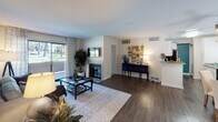 Located at 10757 Lemon Ave in Rancho Cucamonga, CA, this single-floor residence offers a thoughtfully designed layout with modern finishes throughout. The living room is a welcoming centerpiece, featuring rich wood-style flooring, a tiled fireplace, and a sliding glass door that invites natural light and outdoor views. A secondary sitting area near the front entry provides additional flexible living space with the same warm flooring and neutral tones.

The kitchen is efficiently arranged with white shaker cabinetry, grey countertops, a stainless steel double-basin sink, and a dishwasher. A window above the sink brings in natural light, while a tall pantry cabinet adds generous storage.

The bedrooms feature plush carpeting and bold teal accent walls that lend each room a vibrant, cohesive character. The primary bedroom includes a sliding mirrored closet and direct access to an en-suite bathroom. Both bathrooms are finished with white vanity cabinetry, tub-shower combinations, and wood-style flooring, with one featuring a clerestory window for added brightness.

Throughout the space, a consistent palette of soft greys, whites, and teal accents creates a modern and inviting atmosphere well-suited for comfortable everyday living.