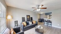 Located at 2909 Hayes Rd in Houston, TX, this efficiently designed one-bedroom, one-bathroom unit offers a well-organized single-floor layout. The open-concept living and dining area is bright and welcoming, featuring light wood-look flooring, neutral gray walls, and a ceiling fan with light fixture. A large window allows natural light to fill the space, creating an airy atmosphere. The living area flows seamlessly into the dining space, making it ideal for everyday living and entertaining.

The galley-style kitchen is thoughtfully appointed with gray cabinetry, marble-look countertops, black appliances including a range and refrigerator, and a stainless steel sink. Ample cabinet storage lines both sides of the kitchen, maximizing functionality within the compact layout.

The bedroom offers a comfortable, private retreat with plush carpeting, a ceiling fan, and a window with outdoor views. A dedicated closet provides convenient storage. The full bathroom features a clean, white tiled tub and shower combination with a patterned curtain and light wood-look flooring.

Throughout the unit, consistent neutral tones and modern finishes create a cohesive and practical living environment well-suited for those seeking comfortable urban living in the Houston area.